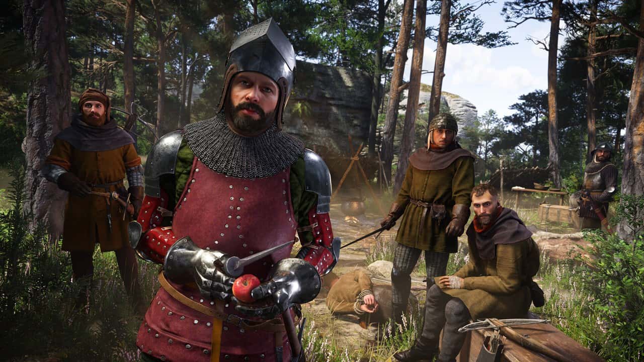 Henry in red and steel armor standing with soldiers in a forest camp in Kingdom Come: Deliverance II