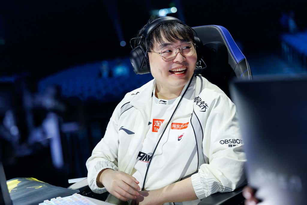 A smiling Top Esports player on stage during Day 2 of the Worlds 2026 Swiss Stage