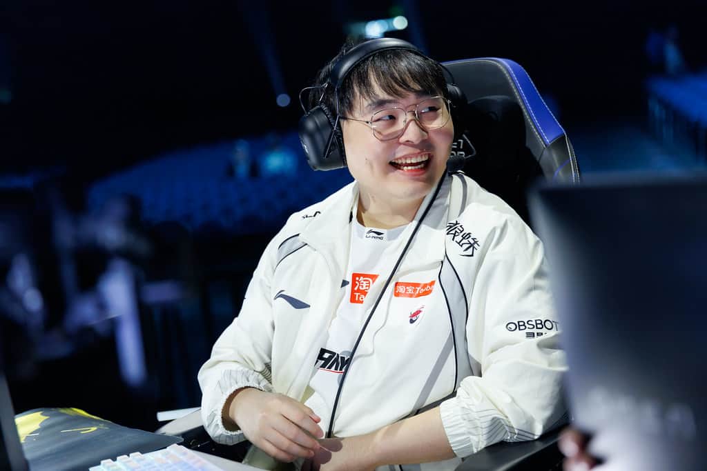 A smiling Top Esports player on stage during Day 2 of the Worlds 2026 Swiss Stage