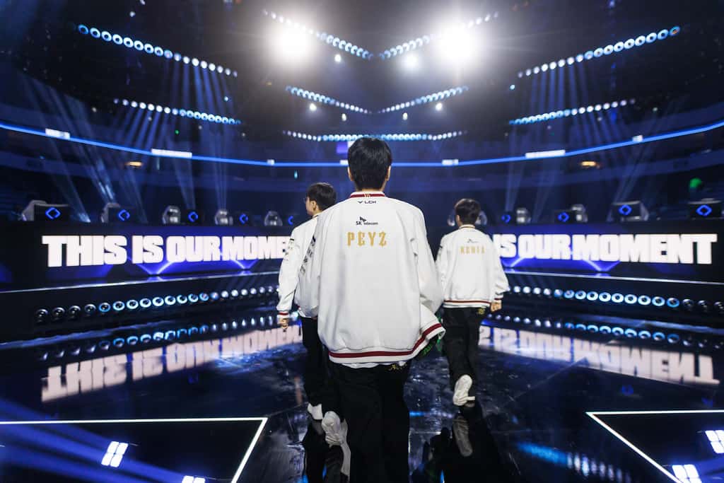 Two players walking towards a brightly lit stage on Day 4 of the Worlds 2026 Swiss Stage