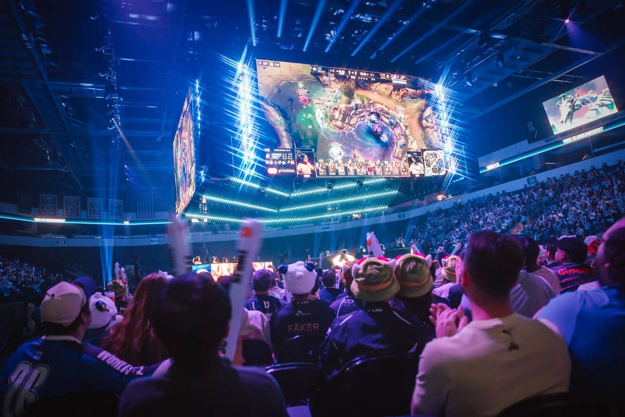 Fans watching a match under a giant screen at the Worlds 2026 Swiss stage