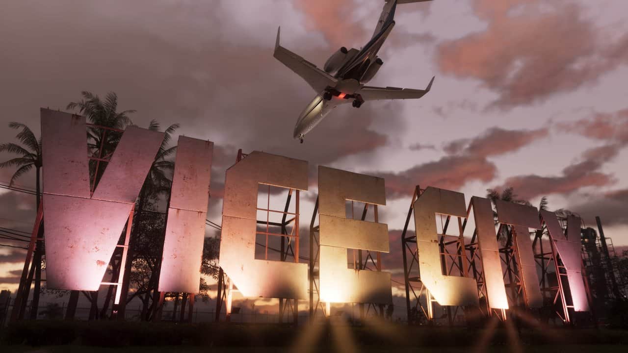 A passenger jet flying low over the giant Vice City sign at sunset in GTA 6