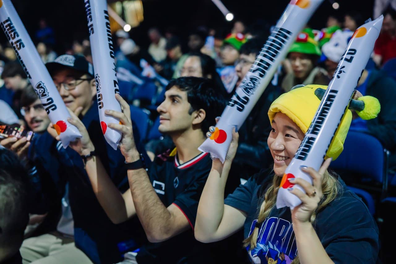 League of Legends fans waving inflatable cheer sticks in the crowd on Day 3 of the Worlds 2026 Swiss Stage